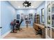 Home office featuring hardwood floors, natural light, and built-in shelving for added storage at 18577 Clay Hill Rd, Dade City, FL 33523