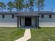 Outbuilding has black trim and awning at 18577 Clay Hill Rd, Dade City, FL 33523