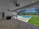 An inviting outdoor space featuring a covered patio, swimming pool and dining area at 18577 Clay Hill Rd, Dade City, FL 33523
