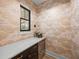 Charming pantry with unique cloud wallpaper, window, and custom cabinets and drawers at 18577 Clay Hill Rd, Dade City, FL 33523