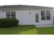 Backyard features a grassy lawn, established landscaping, and a rear door at 1922 Sassafras Dr, Wesley Chapel, FL 33543