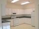 Functional kitchen with white cabinetry, essential appliances, and ample counter space at 1922 Sassafras Dr, Wesley Chapel, FL 33543