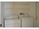 Laundry room with washer, dryer and wire shelving for storage solutions at 1922 Sassafras Dr, Wesley Chapel, FL 33543