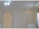 Interior view showcasing neutral walls, archway details, ceiling fan, and natural light at 1922 Sassafras Dr, Wesley Chapel, FL 33543