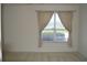 Bright living room with neutral walls and carpets, featuring a large window overlooking a green view at 1922 Sassafras Dr, Wesley Chapel, FL 33543