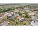 Bird's-eye view of a community with a mix of homes, green spaces, and winding roads at 202 Grayson Ct, Sun City Center, FL 33573