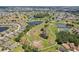 Overhead view of homes near lakes, grassy expanses and walking trails at 202 Grayson Ct, Sun City Center, FL 33573