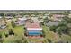 Overhead view of house with a screened-in pool and well-manicured lawn at 202 Grayson Ct, Sun City Center, FL 33573