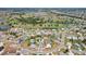 Expansive aerial view of a residential area featuring homes, ponds and golf course at 202 Grayson Ct, Sun City Center, FL 33573