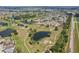 Scenic aerial view of a community with ponds, walking paths and adjacent to a highway at 202 Grayson Ct, Sun City Center, FL 33573