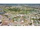 Overhead view of a residential area near a golf course, with houses, ponds, and tree coverage at 202 Grayson Ct, Sun City Center, FL 33573