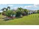 Landscaped backyard with a screened-in pool and lush tropical foliage at 202 Grayson Ct, Sun City Center, FL 33573