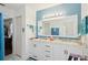 Bright bathroom featuring a dual sink vanity with white cabinets and a framed mirror at 202 Grayson Ct, Sun City Center, FL 33573