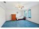 Cozy bedroom with blue carpeting, a ceiling fan and a dresser next to the bed at 202 Grayson Ct, Sun City Center, FL 33573