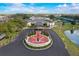 Inviting community hall with a memorial, surrounded by lush landscaping and a pond, creating a serene atmosphere at 202 Grayson Ct, Sun City Center, FL 33573