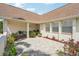 Inviting courtyard featuring brick pavers, plants, flowers, and an outdoor sitting area at 202 Grayson Ct, Sun City Center, FL 33573