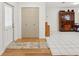 Bright entryway featuring hardwood floors, a closet, and a view into the spacious living area at 202 Grayson Ct, Sun City Center, FL 33573