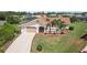 Charming home featuring a well-manicured lawn, mature palms, and a two-car garage at 202 Grayson Ct, Sun City Center, FL 33573