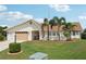 Attractive house featuring a well-kept lawn, vibrant foliage, and ample driveway space at 202 Grayson Ct, Sun City Center, FL 33573