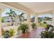 Cozy porch with potted plants, tile flooring, and an ornate gate, creating a welcoming entrance at 202 Grayson Ct, Sun City Center, FL 33573