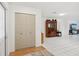 Hallway featuring a closet with folding doors and an antique cabinet with tile flooring and fresh white paint at 202 Grayson Ct, Sun City Center, FL 33573
