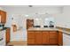Open-concept kitchen features an island with granite countertops and views to living room at 202 Grayson Ct, Sun City Center, FL 33573