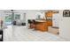 Open floor plan featuring a kitchen island, tile flooring, and views of the pool and outdoor living area at 202 Grayson Ct, Sun City Center, FL 33573