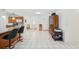 Open floor plan featuring a kitchen island, tile flooring, and views of the living room at 202 Grayson Ct, Sun City Center, FL 33573
