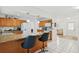 Bright kitchen with a granite countertop island and pendant lighting at 202 Grayson Ct, Sun City Center, FL 33573