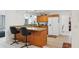 Bright kitchen featuring granite countertops, wooden cabinets, tile flooring, and modern appliances at 202 Grayson Ct, Sun City Center, FL 33573