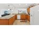 Bright and inviting kitchen with granite countertops, white appliances, and wood cabinets at 202 Grayson Ct, Sun City Center, FL 33573