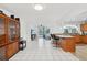 Open floor plan featuring a kitchen island, tile flooring, and views of the pool and outdoor living area at 202 Grayson Ct, Sun City Center, FL 33573