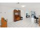 Bright, open living space with tile floors and access to a pool area, featuring an antique cabinet at 202 Grayson Ct, Sun City Center, FL 33573