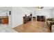Bright living room featuring a fireplace, bar area, and wood laminate flooring at 202 Grayson Ct, Sun City Center, FL 33573