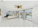 Spacious living room featuring large windows with views of the pool, offering lots of natural light at 202 Grayson Ct, Sun City Center, FL 33573