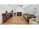 Inviting living room with hardwood floors, a cozy fireplace, and plenty of natural light at 202 Grayson Ct, Sun City Center, FL 33573