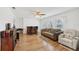 Bright and open living room featuring hardwood floors, a ceiling fan, and large windows at 202 Grayson Ct, Sun City Center, FL 33573