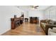 Bright living room featuring a fireplace, bar area, and wood laminate flooring at 202 Grayson Ct, Sun City Center, FL 33573