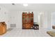 Open living room featuring tile flooring and an antique cabinet with fresh white paint on the walls at 202 Grayson Ct, Sun City Center, FL 33573