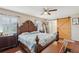 Large main bedroom with a ceiling fan and a rustic sliding barn door at 202 Grayson Ct, Sun City Center, FL 33573