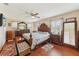 Spacious main bedroom with a ceiling fan and hardwood floors at 202 Grayson Ct, Sun City Center, FL 33573