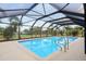 The enclosed pool features convenient steps with a sturdy rail for easy access at 202 Grayson Ct, Sun City Center, FL 33573