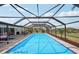 Backyard in-ground swimming pool with a fully enclosed screen for privacy at 202 Grayson Ct, Sun City Center, FL 33573