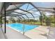 Screened-in pool with clear blue water and a sunny sky view at 202 Grayson Ct, Sun City Center, FL 33573