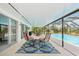Inviting screened patio with outdoor dining area overlooking the sparkling pool at 202 Grayson Ct, Sun City Center, FL 33573
