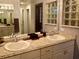 Bathroom featuring granite countertops with double sinks at 21103 Patio View Ct # 3302, Lutz, FL 33558