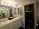 Bathroom featuring granite countertops with double sinks and decorative lighting at 21103 Patio View Ct # 3302, Lutz, FL 33558