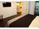 Bedroom with a large flat screen tv, dark carpet and balcony access at 21103 Patio View Ct # 3302, Lutz, FL 33558
