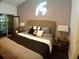 Comfortable bedroom featuring a cozy bed, ambient lighting, and access to a balcony with scenic views at 21103 Patio View Ct # 3302, Lutz, FL 33558