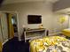 Comfortable bedroom featuring a flat-screen TV and a console table, perfect for relaxation and entertainment at 21103 Patio View Ct # 3302, Lutz, FL 33558
